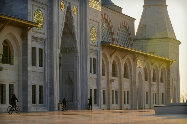 a person riding a bike in front of a building, a marble sculpture, inspired by Osman Hamdi Bey, pexels contest winner, hurufiyya, mosque interior, gray, sun at dawn, archviz