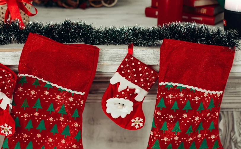 a couple of stockings sitting on top of a mantle, pexels, santa, 🦩🪐🐞👩🏻🦳, close-up shot from behind, profile image