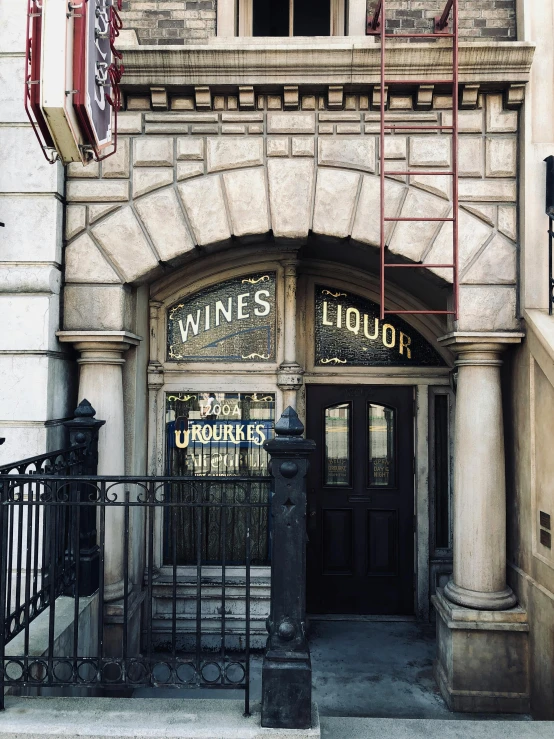 a building with a sign that says wine's liquor, a photo, by Kyle Lambert, art nouveau, harry, vintage disney, new york back street, 2019 trending photo
