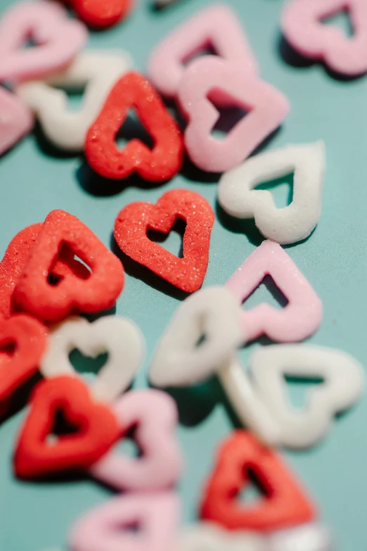 a bunch of hearts sitting on top of a table, pexels, pink white turquoise, red velvet, low detail, diecut