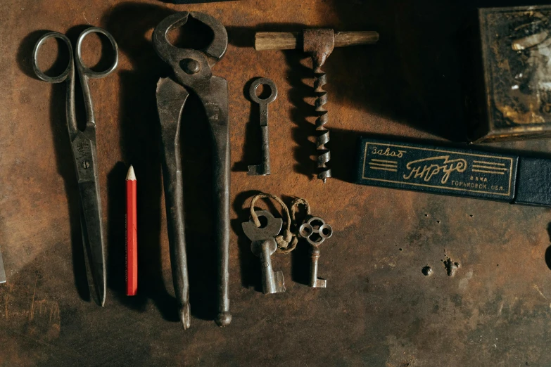 a bunch of tools sitting on top of a table, a still life, pexels contest winner, assemblage, ancient keys, brown, blacksmith product design, an escape room in a small