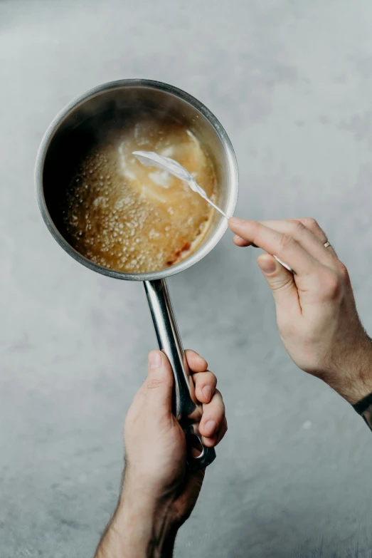 a person holding a pan with food in it, syrup, clean long lines, vanilla, boke