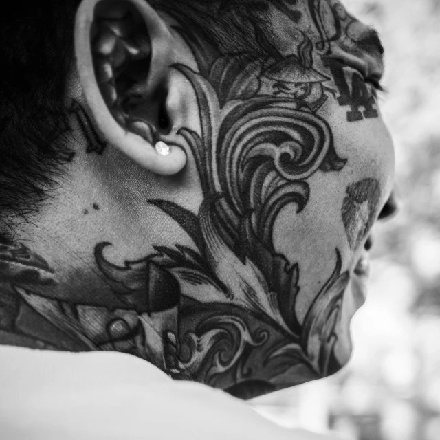 a man with a tattoo on his face, a tattoo, by Adam Marczyński, pexels contest winner, asian hyperdetailed, gauged ears, black and whitehighly detailed, intricate sharp focus