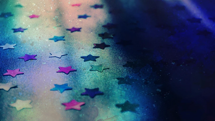 a close up of a table with stars on it, by Julia Pishtar, trending on pexels, holography, grungy; colorful, magenta and blue, instagram picture, multicoloured