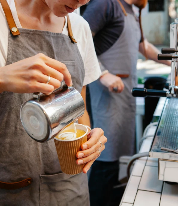 a bari bari serving a cup of coffee, by Austin English, pexels, starbucks aprons and visors, pouring, melbourne, thumbnail
