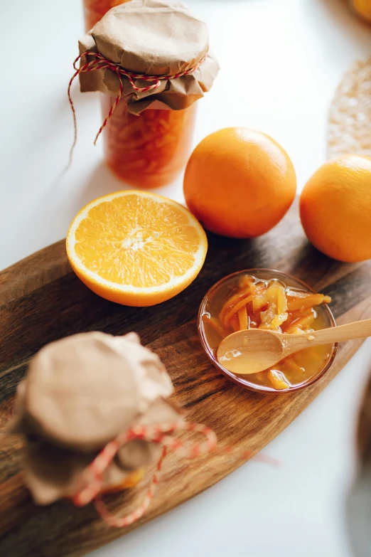 a wooden cutting board topped with oranges and jam, skincare, facemask, dessert, enhanced quality