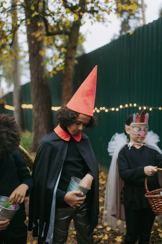 a group of people dressed up in halloween costumes, by Alice Mason, pexels, renaissance, wearing a party hat, over the garden wall, contemplating, little red riding hood