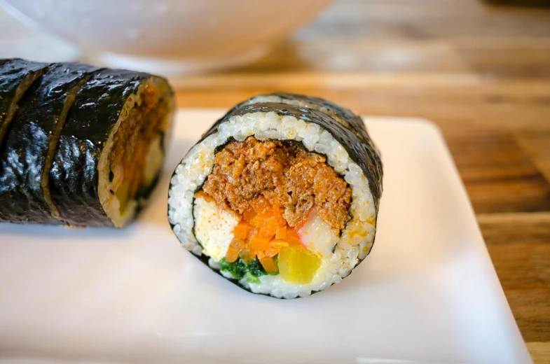 a close up of a sushi roll on a plate, inspired by Maki Haku, unsplash, mingei, square, full daylight, rusty, multi - coloured