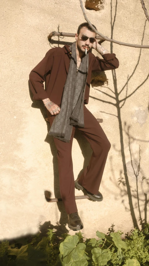 a man leaning against a tree while talking on a cell phone, by Nina Hamnett, renaissance, wearing a worn out brown suit, issey miyake, modeled in poser, top-down shot