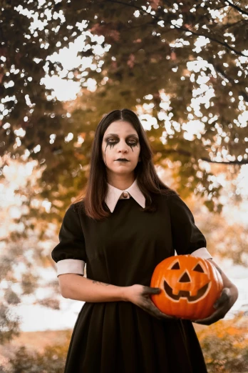a woman in a black dress holding a pumpkin, pexels contest winner, lowbrow, as wednesday addams, square, a handsome, corpsepaint
