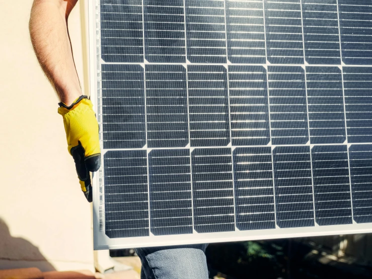 a close up of a person holding a solar panel, by Carey Morris, bauhaus, postprocessed, contain, australian, 1 6 x 1 6