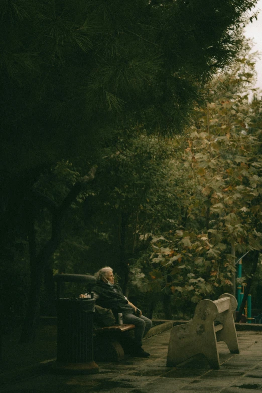 a person sitting on a bench in a park, by Elsa Bleda, an old man, ultrawide cinematic, 4k movie still, tehran