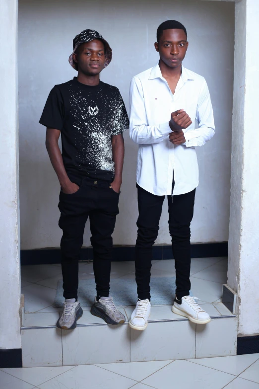 a couple of men standing next to each other, an album cover, inspired by Willian Murai, pexels contest winner, wearing a dark shirt and jeans, kano), teenager, full - body - front - shot