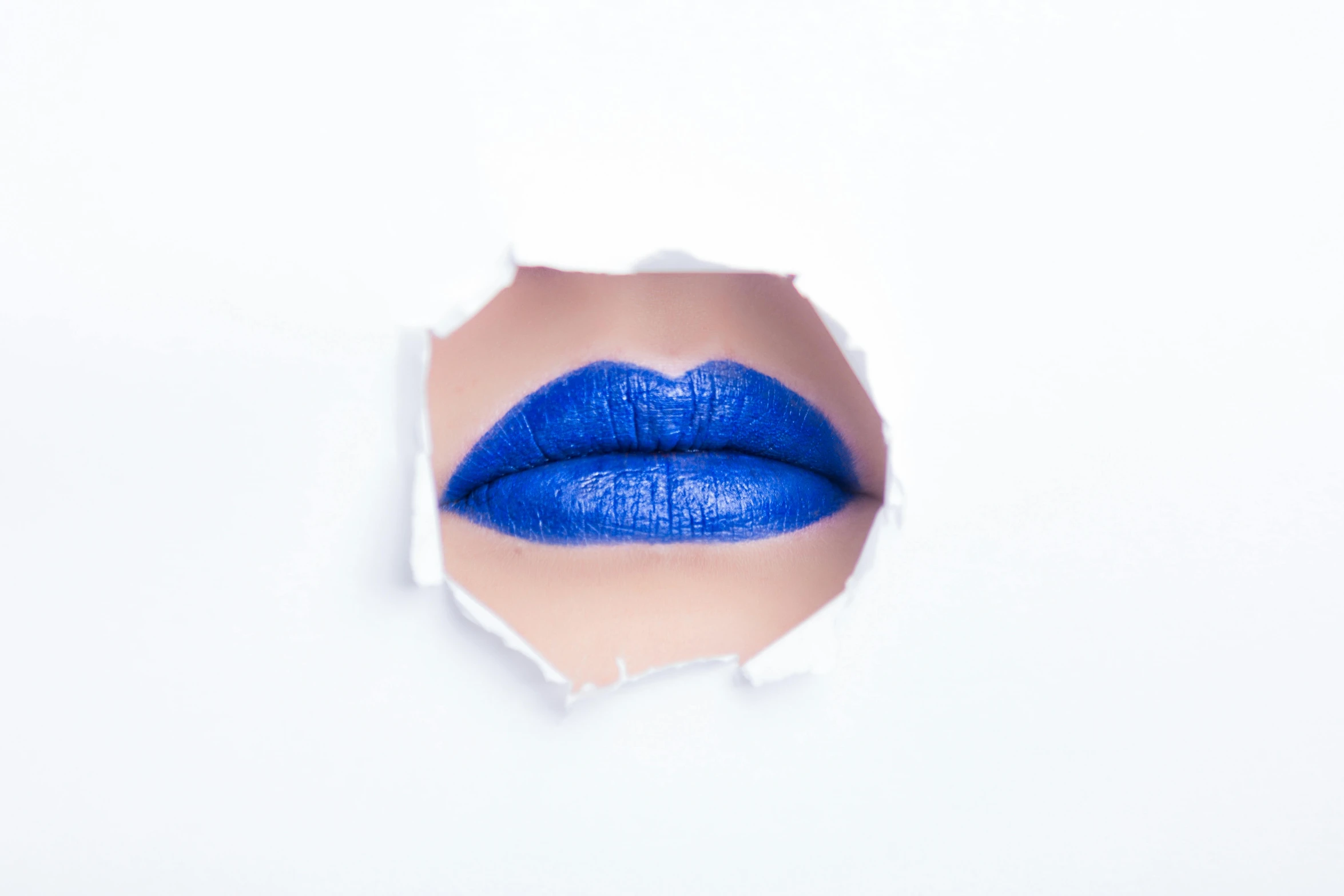 a close up of a person's lips through a hole in a paper, inspired by Yves Klein, trending on pexels, pop art, blue lipstick, on white background, blue undergarments, vibrant.-h 704