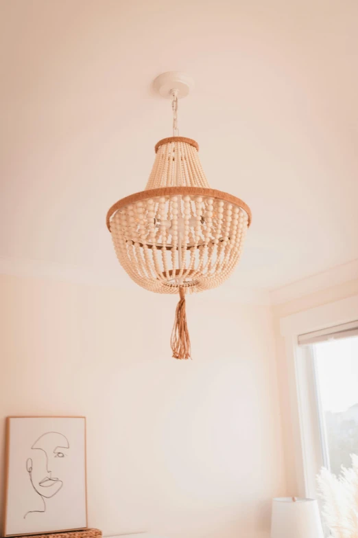 a bed room with a neatly made bed and a chandelier, by Nicolette Macnamara, unsplash contest winner, light and space, made of beads and yarn, clamp shell lighting, filled with natural light, product lighting