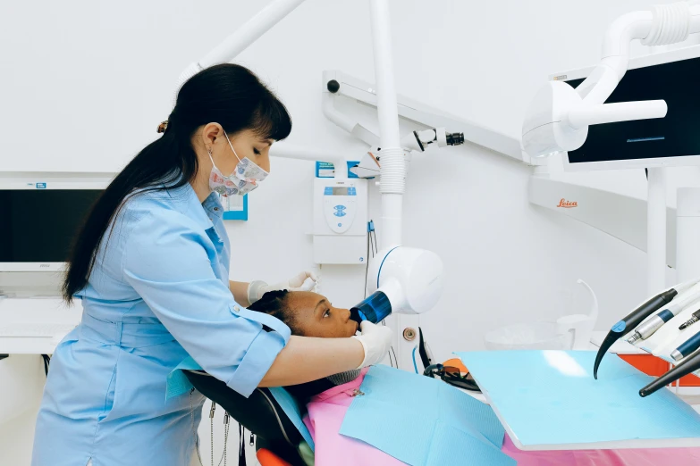 a woman getting her teeth examined by a dentist, pexels contest winner, hurufiyya, mai anh tran, thumbnail, sky blue, profile pic