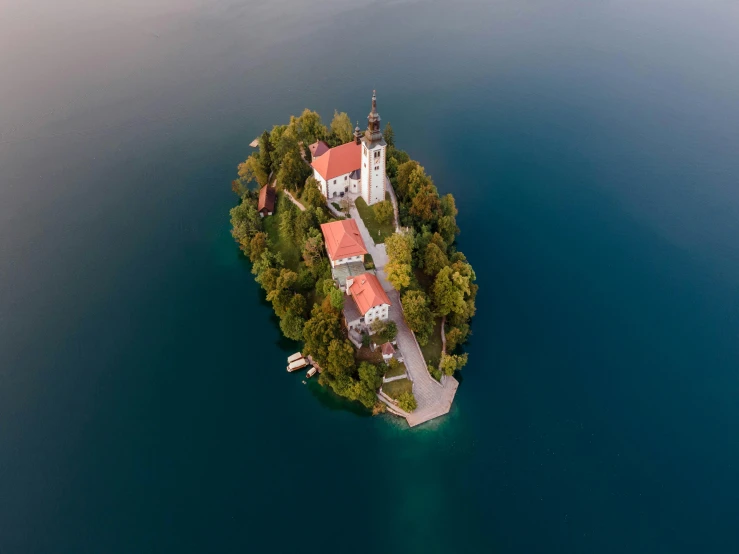 a small island in the middle of a body of water, by Sebastian Spreng, pexels contest winner, slovenian, photographic isometric cathedral, “the ultimate gigachad, floating crown