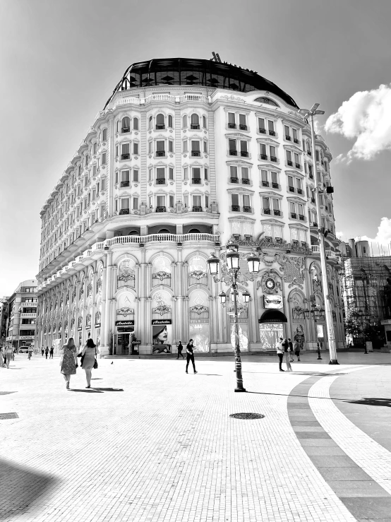 a black and white photo of a large building, a black and white photo, by andrei riabovitchev, art nouveau, urban plaza, nice weather, monochrome!!!!!, elena masci