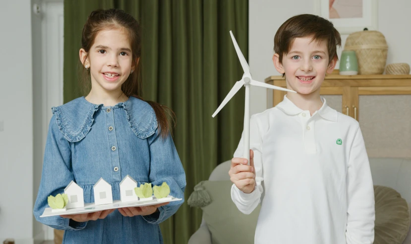 a couple of kids standing next to each other, pexels contest winner, fantastic realism, green energy, replica model, at home, 15081959 21121991 01012000 4k