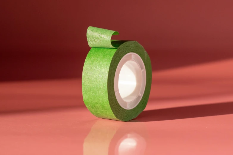 a roll of green tape sitting on top of a table, inspired by Maki Haku, trending on pexels, renaissance, papercraft, front profile shot, detailed product image, modeled