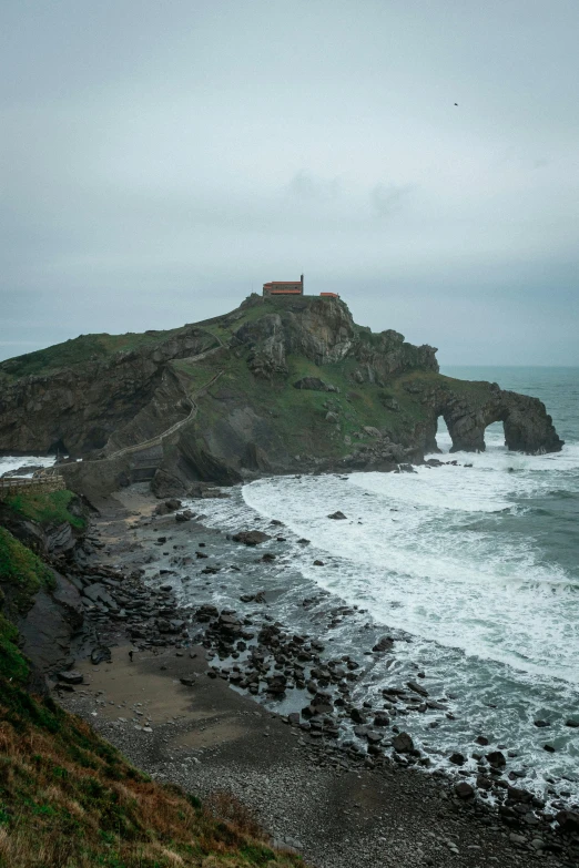 a lighthouse sitting on top of a cliff next to the ocean, a picture, inspired by Santiago Rusiñol, pexels contest winner, renaissance, massive arch, big overcast, 2 5 6 x 2 5 6 pixels, alvaro siza