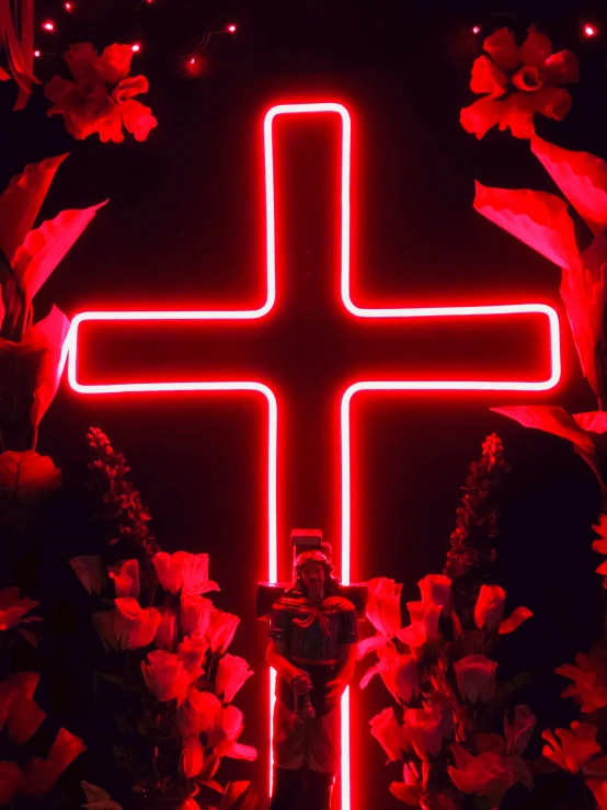 a lighted cross in the middle of a field of flowers, an album cover, inspired by David LaChapelle, pexels, red neon lights inside it, religious sculpture, profile image, made of neon light