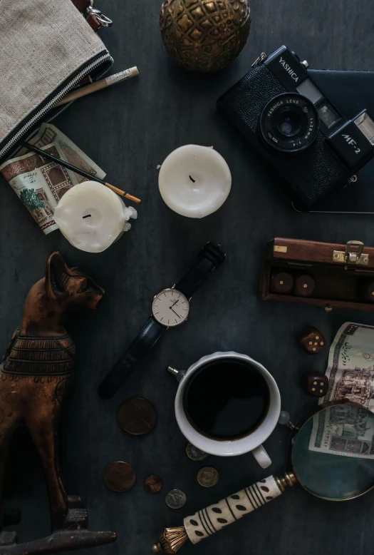 a brown dog sitting on top of a table next to a cup of coffee, a still life, pexels contest winner, time travel theme, exquisite black accessories, camera looking down upon, cash on a sidetable