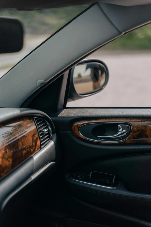 a dog sitting in the driver's seat of a car, by Carey Morris, pexels contest winner, renaissance, polished with visible wood grain, shiny glossy mirror reflections, full view of a sport car, morning detail