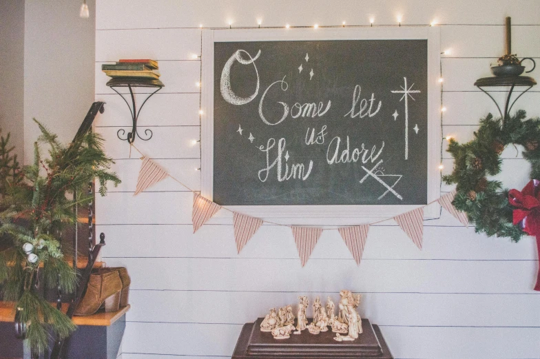 a cake sitting on top of a table in front of a chalkboard, inspired by Ernest William Christmas, light and space, home display, holy themed, white plank siding, featured