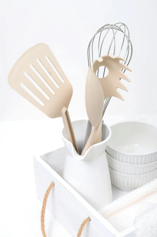 a kitchen utensil holder with utensils in it, inspired by Sarah Lucas, unsplash, dau-al-set, modern studio light soft colour, cream white background, close-up product photo, white wood