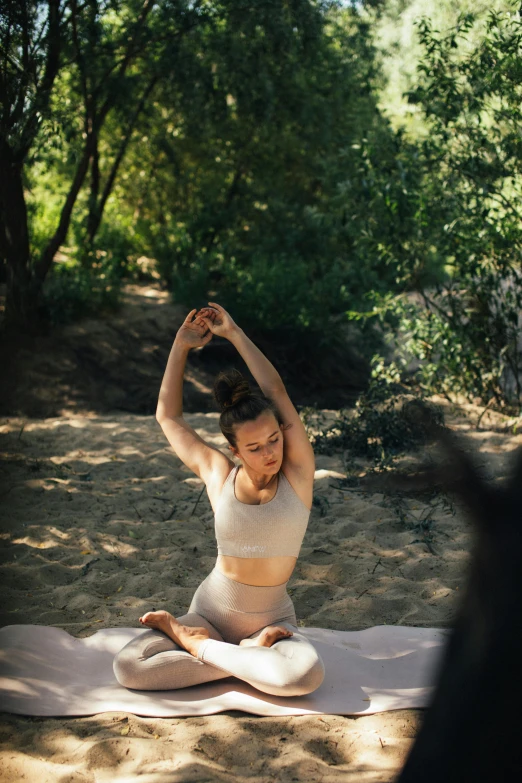 a woman is doing yoga in the woods, unsplash, arabesque, soft shade, on the sand, behind the scenes photo, shaded