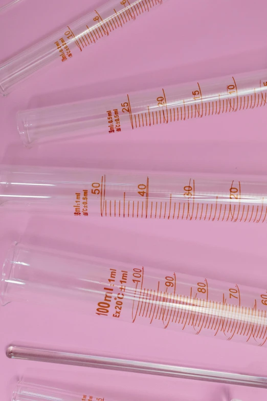 a group of test tubes sitting on top of a pink surface, instagram, plasticien, gauges, detailed product image, 100mm, medical supplies
