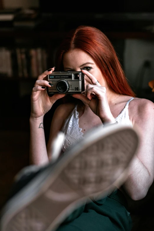 a woman taking a picture of herself with a camera, inspired by Elsa Bleda, short redhead, looking hot, ( redhead, video