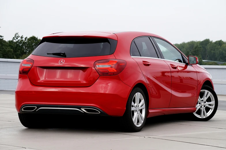 a red mercedes cla parked in a parking lot, a picture, pixabay, square, back turned, istockphoto, romantic lead