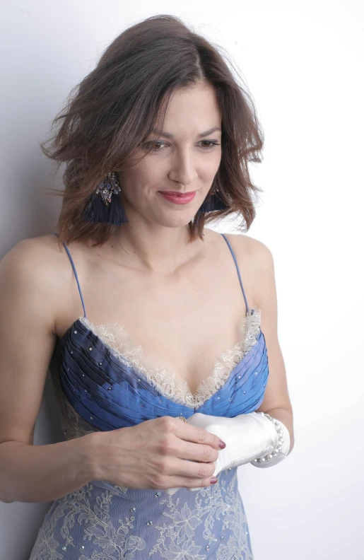 a woman in a blue dress holding a hair dryer, inspired by Zoë Mozert, velvet with lace gown, wearing a low cut tanktop, barbara canepa, portrait image