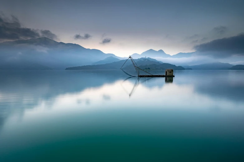 a boat in a body of water with mountains in the background, inspired by Pierre Pellegrini, unsplash contest winner, minimalism, water temple, vietnam, light blue mist, portrait of a sunken ship