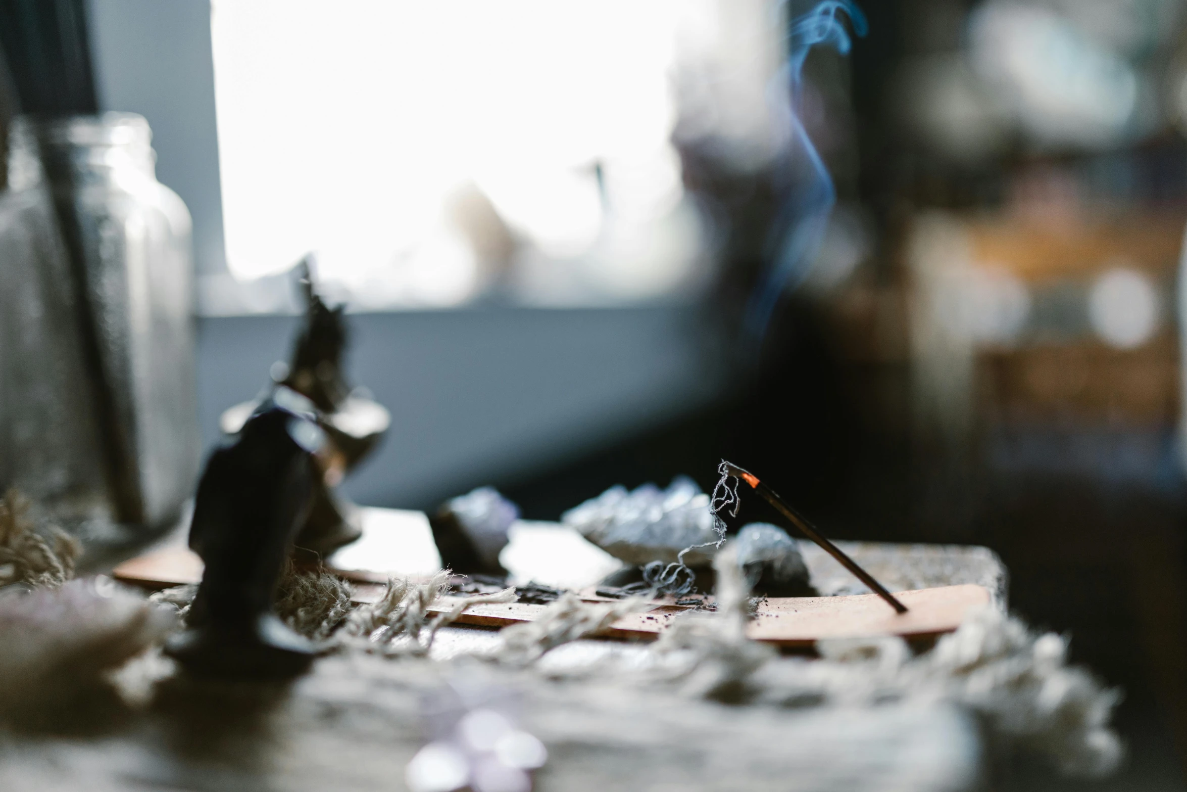 a couple of figurines sitting on top of a table, trending on unsplash, incense, witchy, shot on sony a 7, profile image