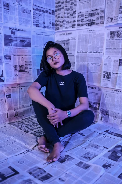 a woman sitting on top of a bed covered in newspapers, an album cover, inspired by Bernardino Mei, unsplash contest winner, wearing small round glasses, in a pitch black room, asian women, violet myers