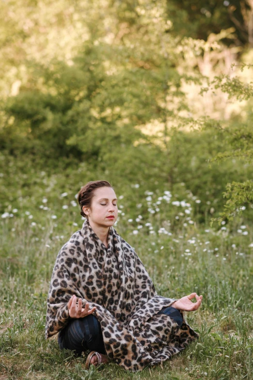 a woman sitting on the ground in a leopard print blanket, unsplash, renaissance, meditating pose, standing in grassy field, portrait image, meditating in lotus position