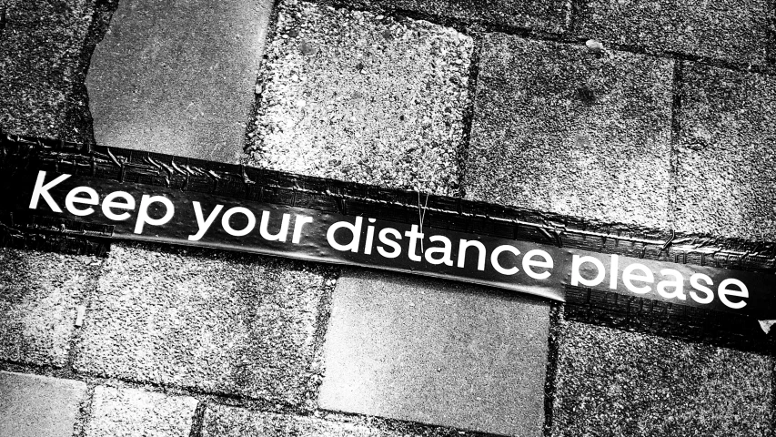 a black and white photo of a street sign, by Caroline Mytinger, pexels, street art, distance!!!!!!! shot, walking over you, large path, resistance