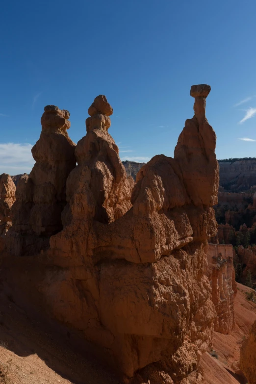 a person standing on top of a rock formation, a statue, three heads, panoramic shot, princess in foreground, square