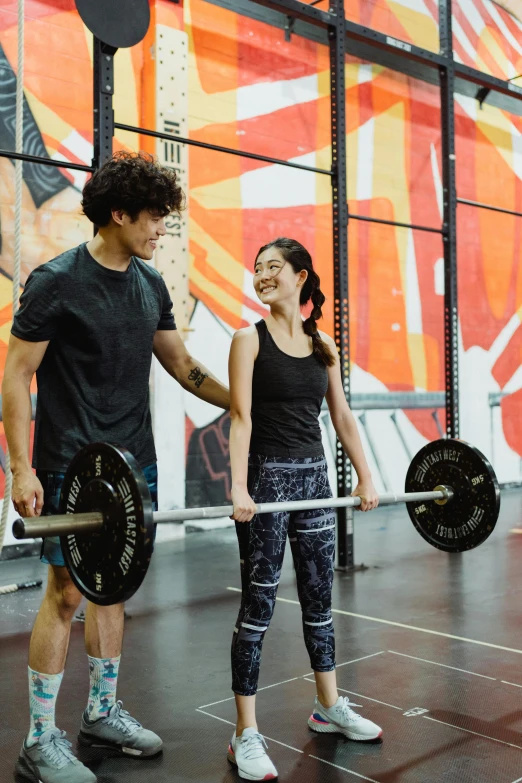 a man and a woman holding a barbell in a gym, by Reuben Tam, sydney park, louise zhang, profile image