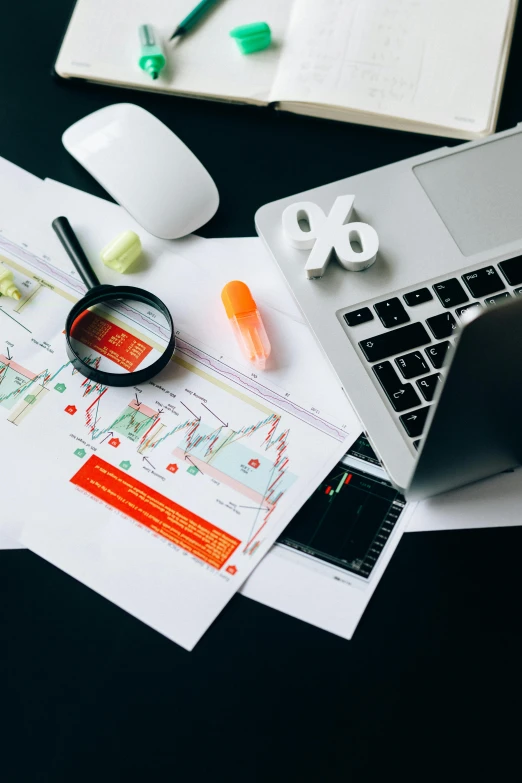 a laptop computer sitting on top of a desk, analytical art, informative graphs and diagrams, currency symbols printed, flatlay, multiple stories