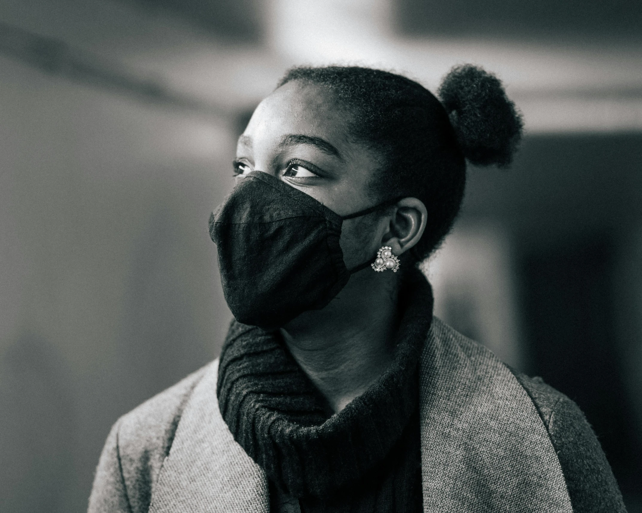 a black and white photo of a woman wearing a face mask, inspired by Carrie Mae Weems, pexels contest winner, a man wearing a black jacket, black girl, scientific, wintermute