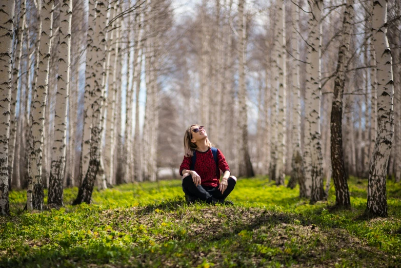 a woman sitting in the middle of a forest, by Julia Pishtar, pexels contest winner, birch trees, nice spring afternoon lighting, avatar image, russian