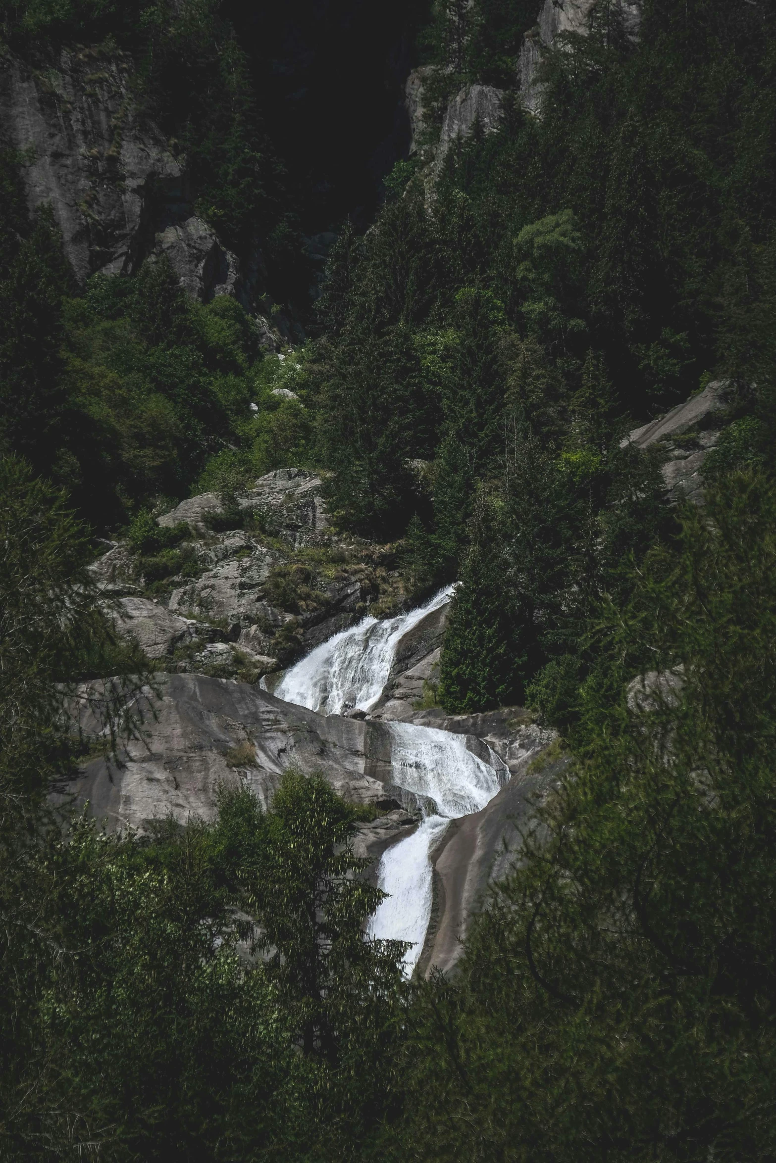 a waterfall in the middle of a forest, unsplash contest winner, les nabis, 2 5 6 x 2 5 6 pixels, chamonix, view from a distance, low quality photo