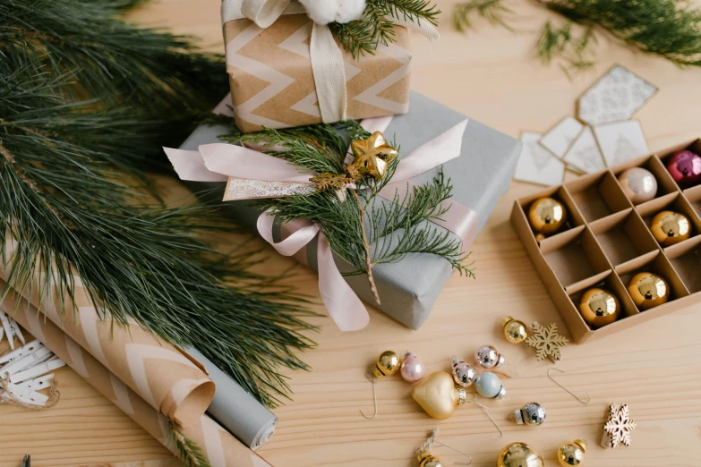 a bunch of christmas ornaments sitting on top of a wooden table, by Alice Mason, trending on pexels, arts and crafts movement, birthday wrapped presents, grey, evergreen, bows