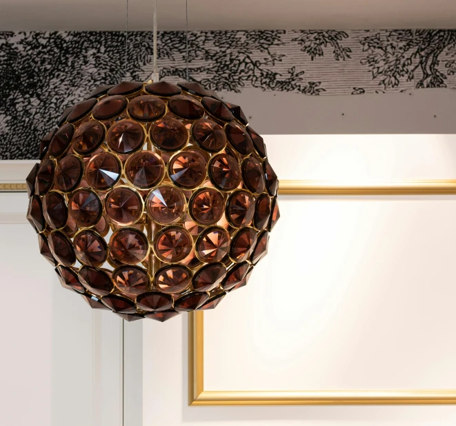 a close up of a light hanging from a ceiling, inspired by André François, garnet, decoration around the room, brown, highly capsuled