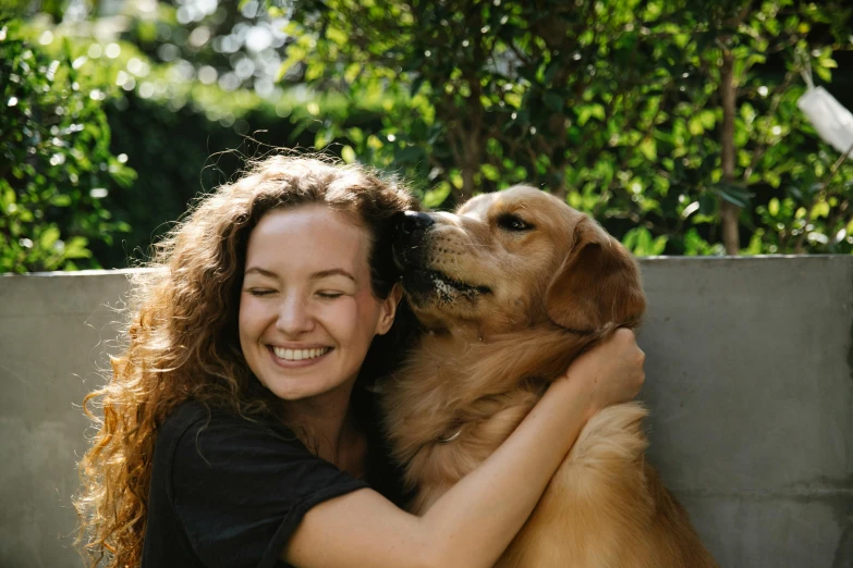 a close up of a person hugging a dog, by Emma Andijewska, pexels contest winner, smiling young woman, golden retriever, avatar image, australian