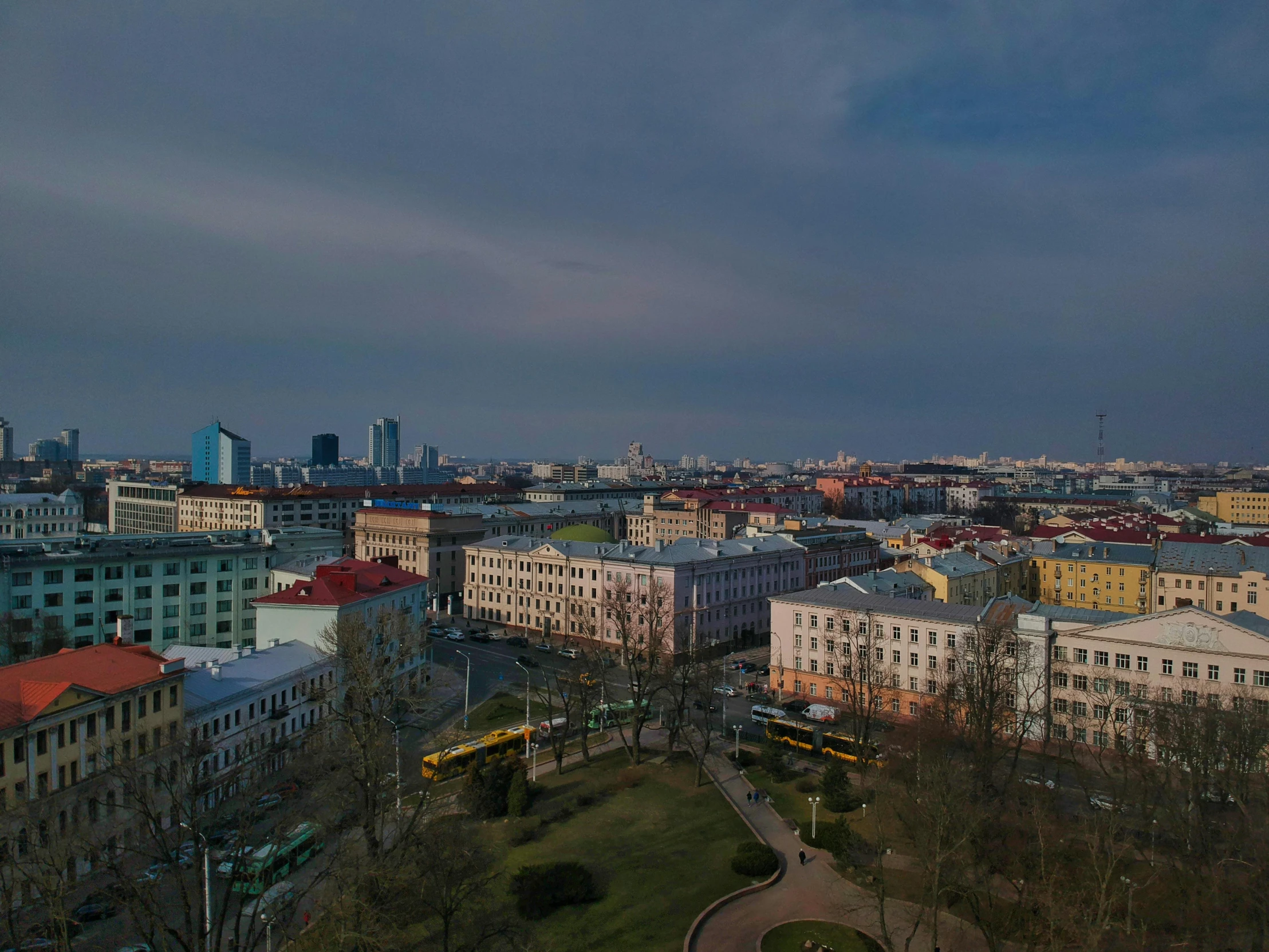 a view of a city from the top of a hill, by Serhii Vasylkivsky, pexels contest winner, socialist realism, square, 8k hdr dusk light, aerial footage, grey